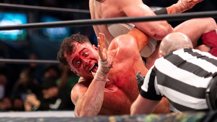 Bryan Danielson puts a bloodied MJF in a submission hold